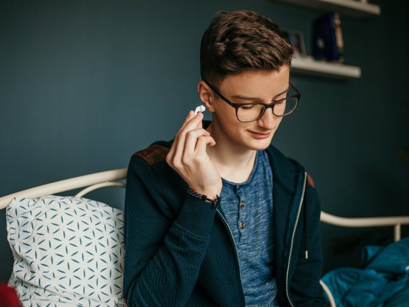 Teenager im Zimmer mit AirPods.