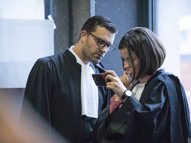 Zwei Anwälte schauen auf ein Smartphone