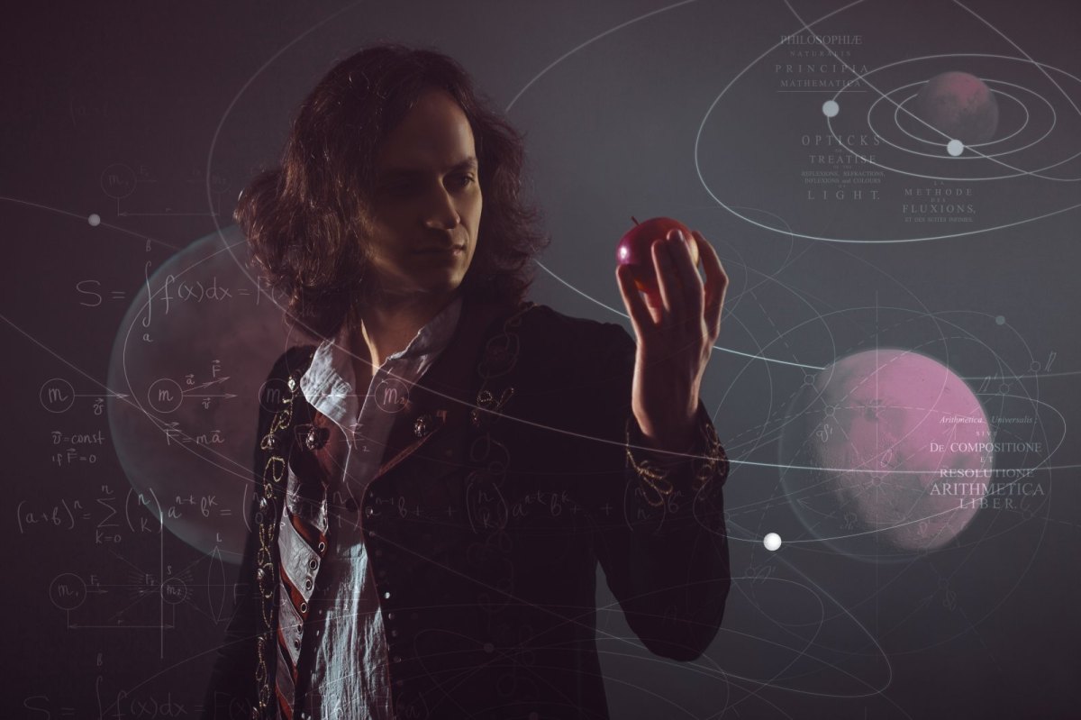 Isaac Newton mit einem Apfel in der Hand.