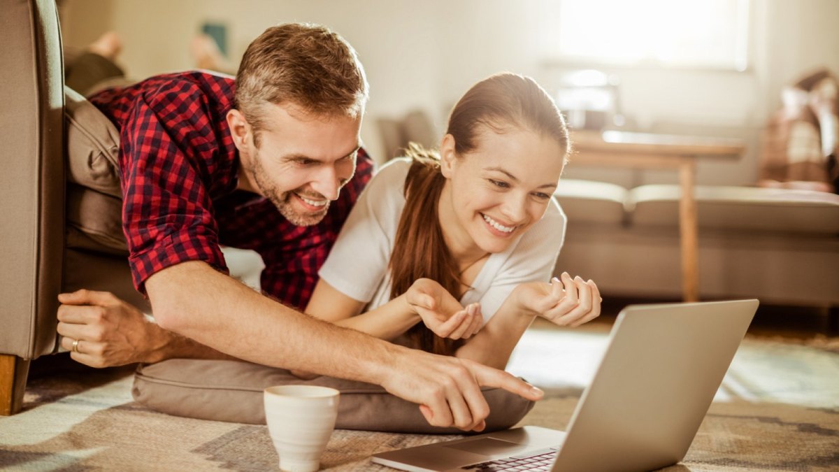 Mann und Frau glücklich am Laptop.