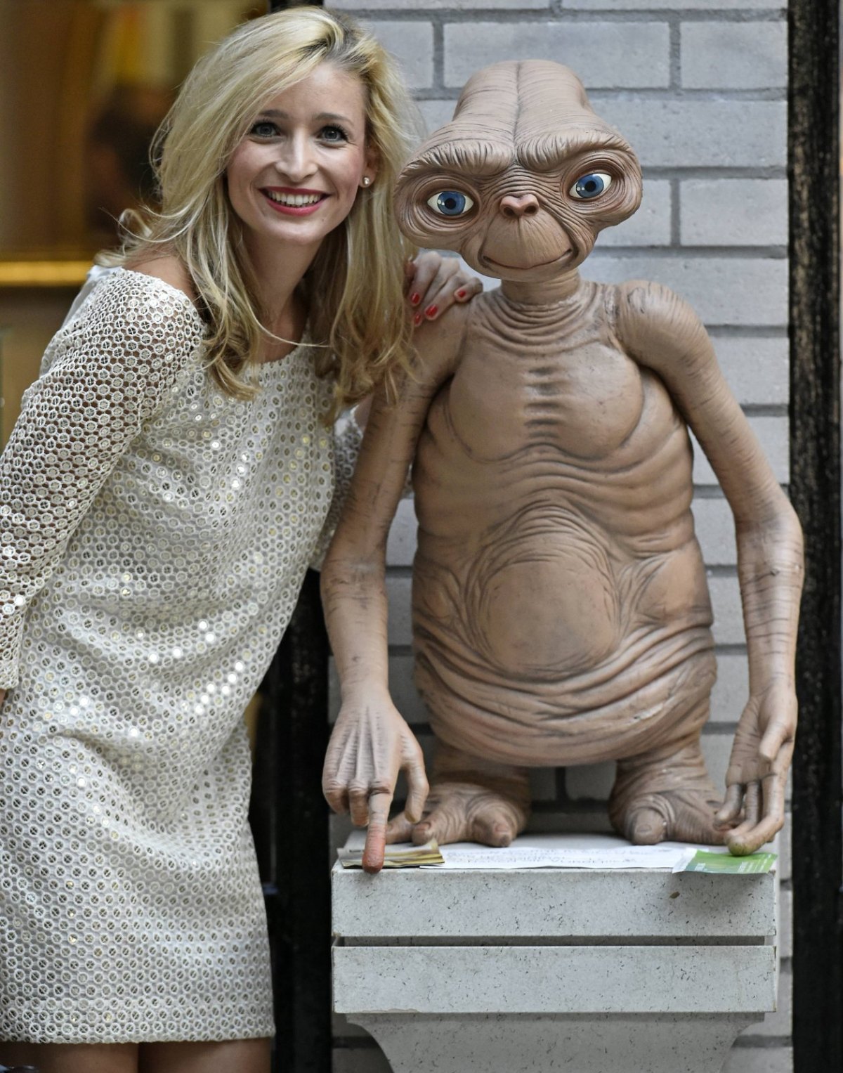 Frau posiert mit Statue von Alien E.T.