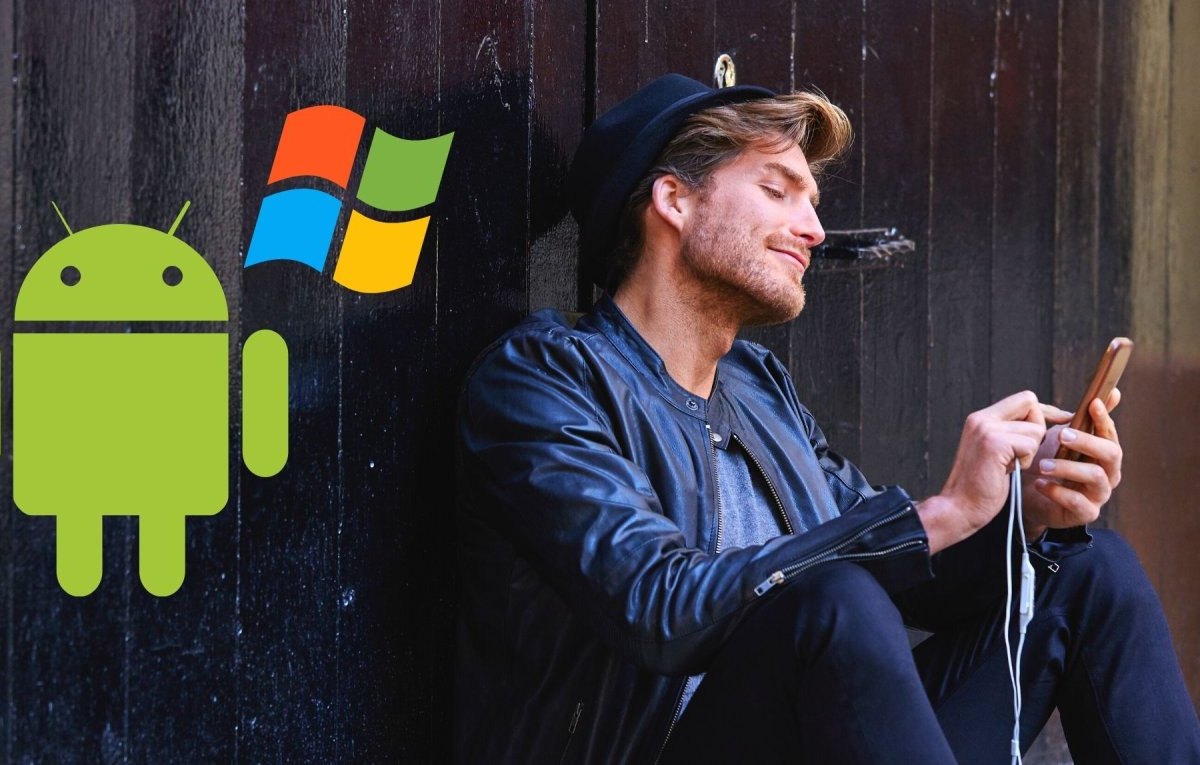 Mann mit Smartphone und die Logos von Android und Windows