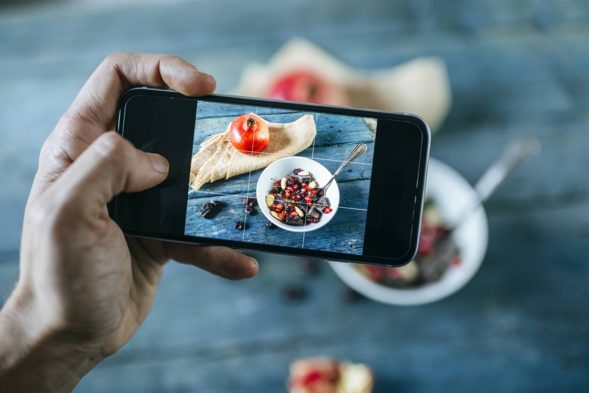 Person fotografiert Essen mit dem Handy