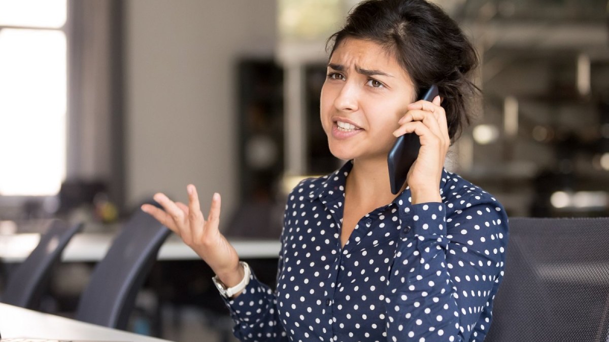 Frau telefoniert genervt am Handy.