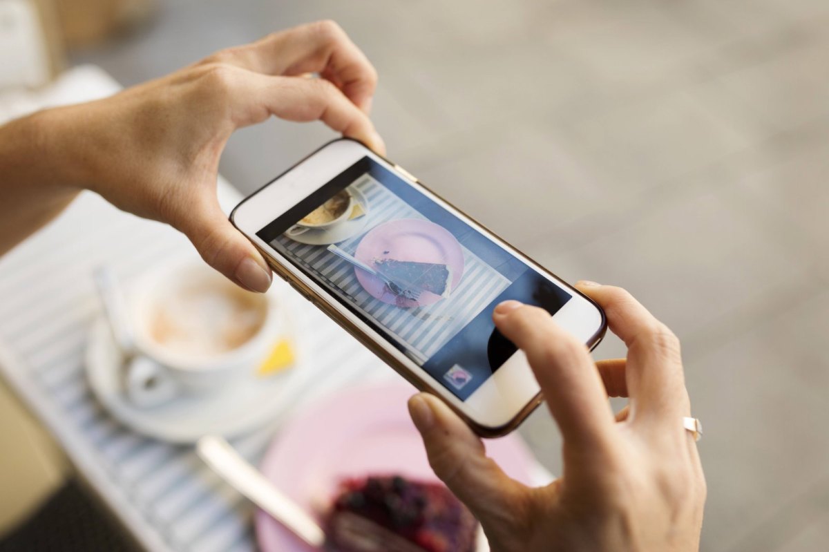 Person macht Foto von Kuchen mit dem iPhone.