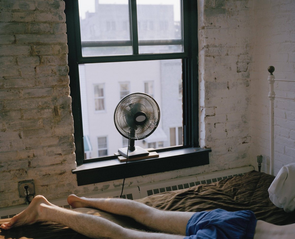 Mann mit Ventilator im Bett