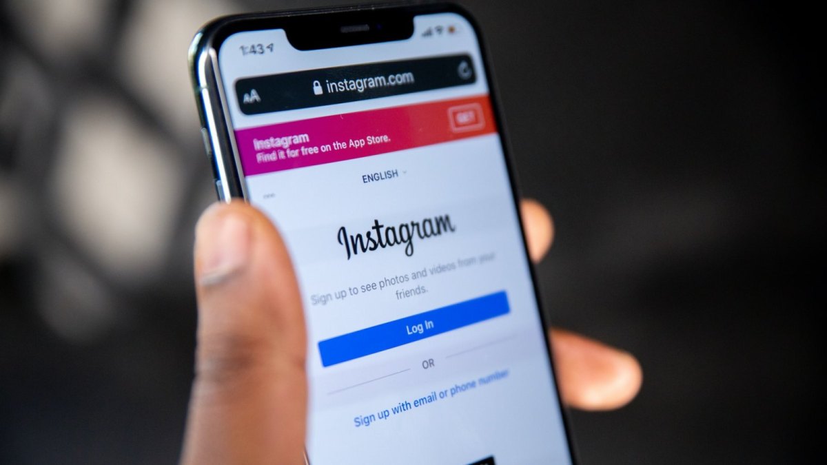 Ein Smartphone in einer Hand auf dem die Instagram-App geöffnet ist.