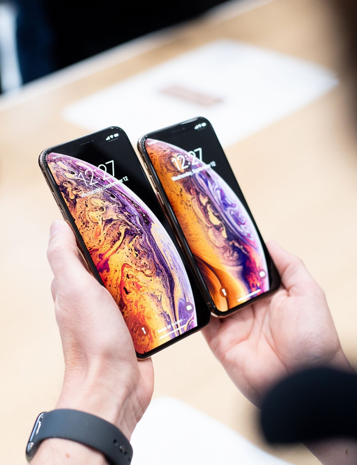 Person hält iPhone XS Max und iPhone XS nebeneinander.