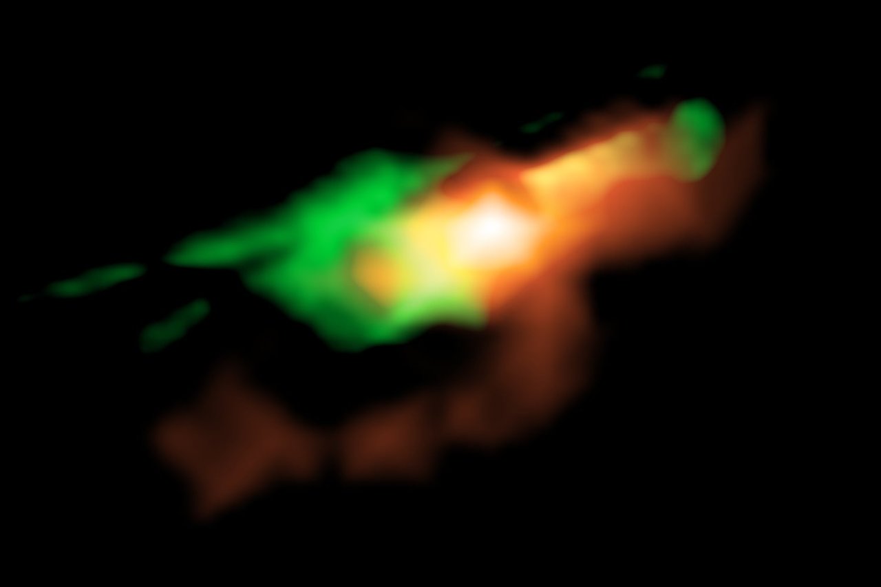 Die Aufnahme des ALMA zeigt ionisierte Materie und Staub (rot) sowie Kohlenmonoxidgas (grün) eines elf Milliarden Lichtjahre entfernten schwarzen Lochs.