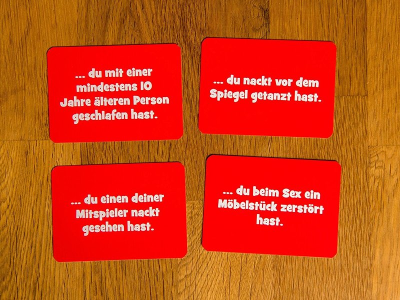 Vier Spielkarten aus dem Trinkspiel "Trinke