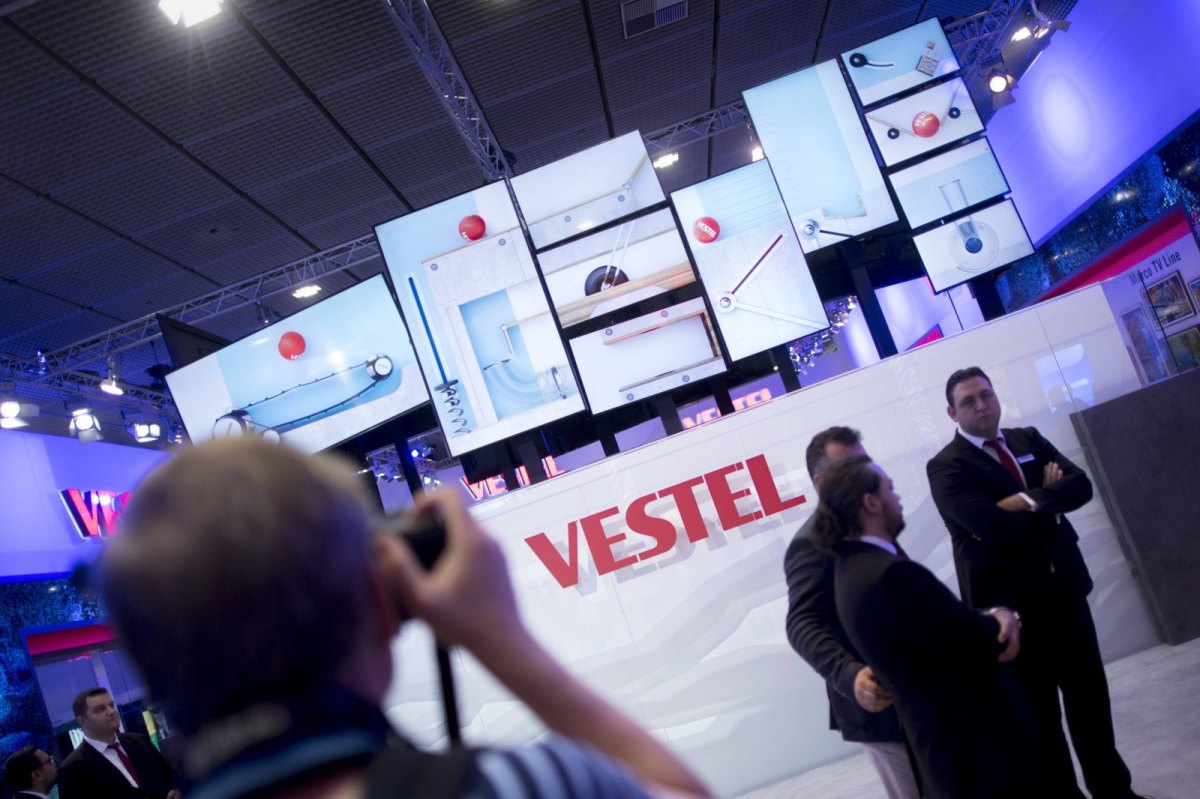 Vetsel Logo mit TVs im Hintergrund auf Messe