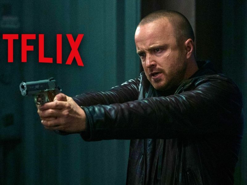 Mann im Regen hält Pistole ausgestreckt. Dazu das Netflix-Logo.