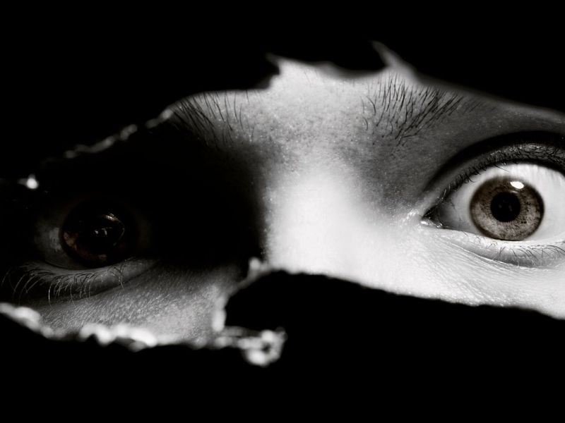 Menschliche Augen schauen durch einen Schlitz