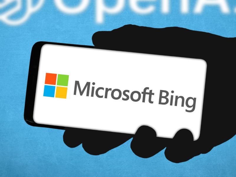 Logo für Microsoft Bing auf einem Handy-Display, dahinter das Logo von OpenAI.