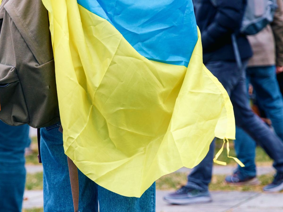 Junge trägt Ukraine Flagge als Cape