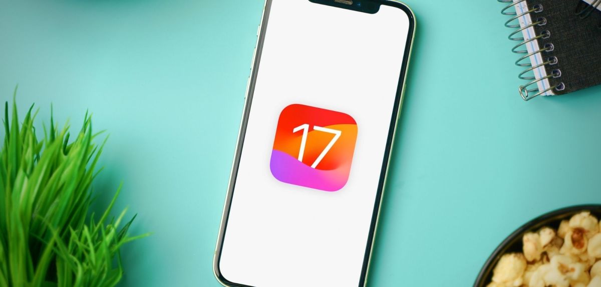Handy mit einem symbolischen Logo für iOS 17 auf dem Display.