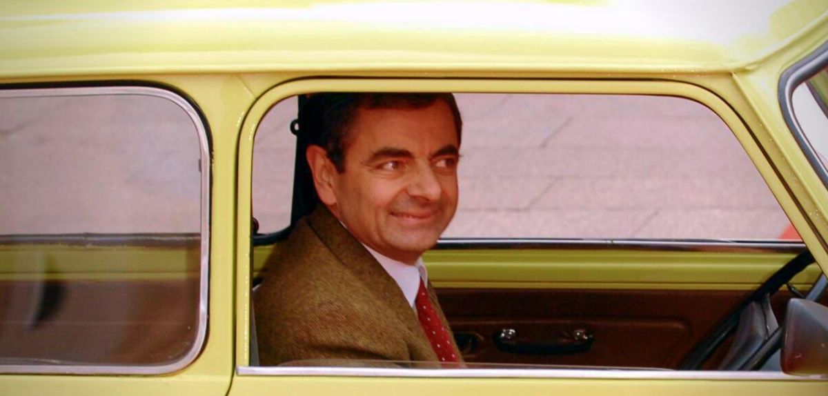 Rowan Atkinson bei einem Premieren-Event in einem Auto.