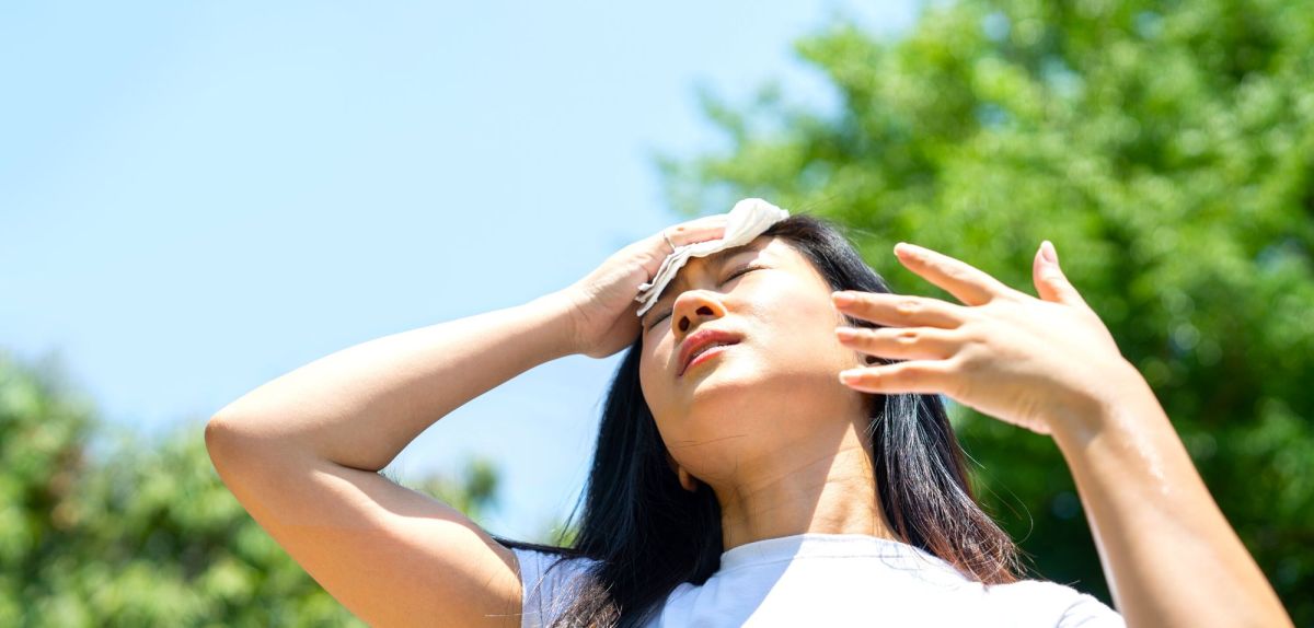 Frau schwitzt in der Sonne.