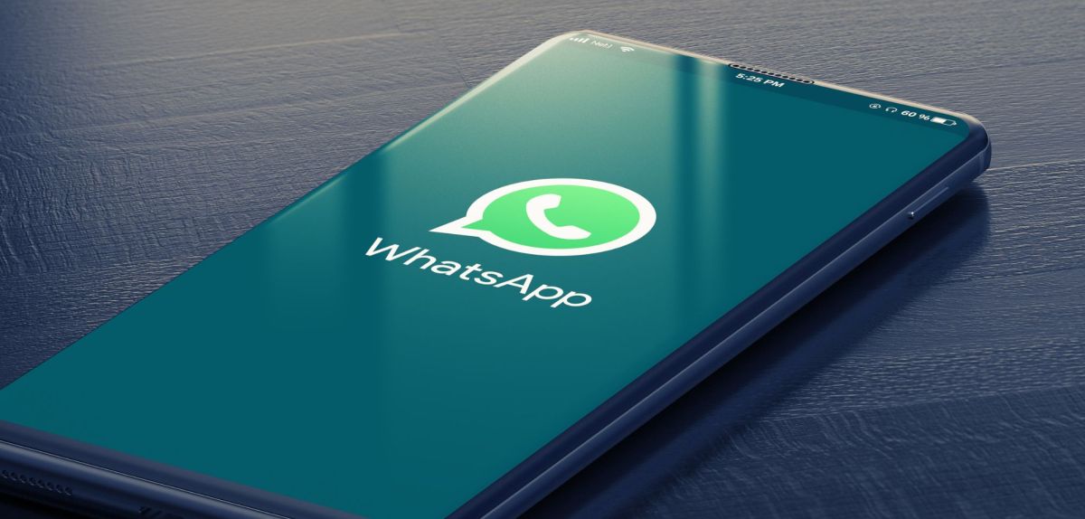 Handy mit WhatsApp-Logo auf dem Display.