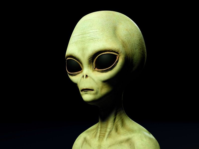 Alien in grün vor einem schwarzen Hintergrund