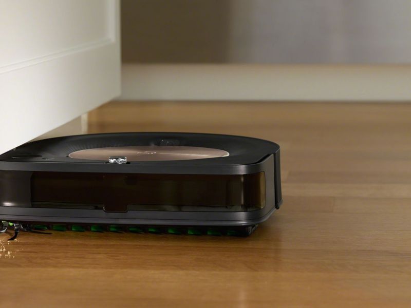 Der iRobot Roomba s9+ saugt den Boden an einer Wand entlang