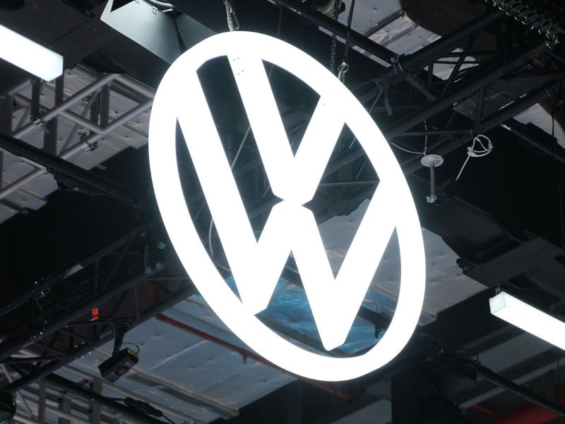 Erleuchtetes VW-Logo an einer Hallendecke.