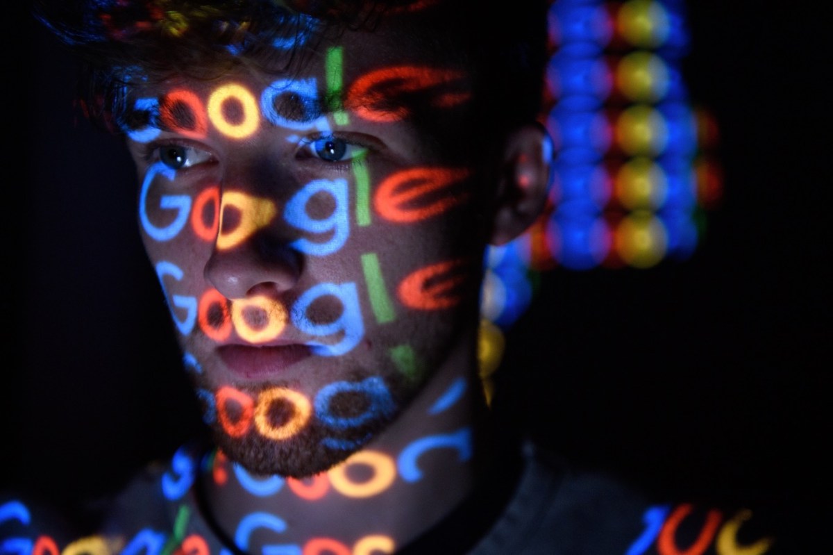 Gesicht eines Mannes, das vom Google-Logo bestrahlt wird