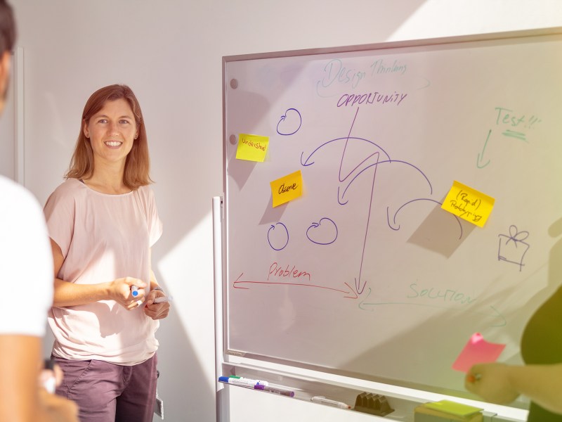 Mitarbeiterin der ALDI SÜD IT vor einem Whiteboard