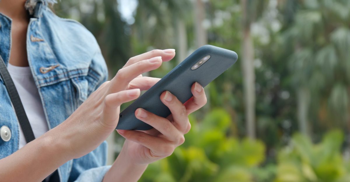 Frau mit Handy in der Natur