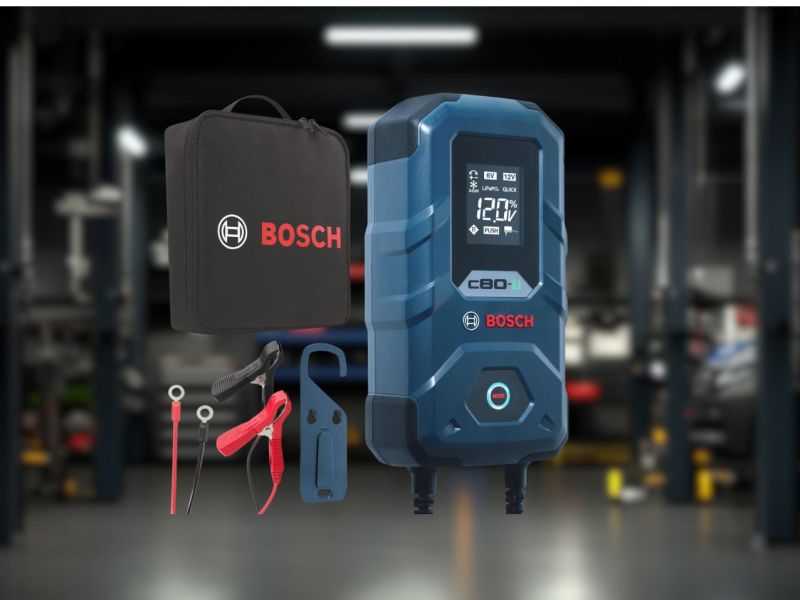 Ein Batterie-Ladegerät von Bosch und im Hintergrund befindet sich eine Werkstatt